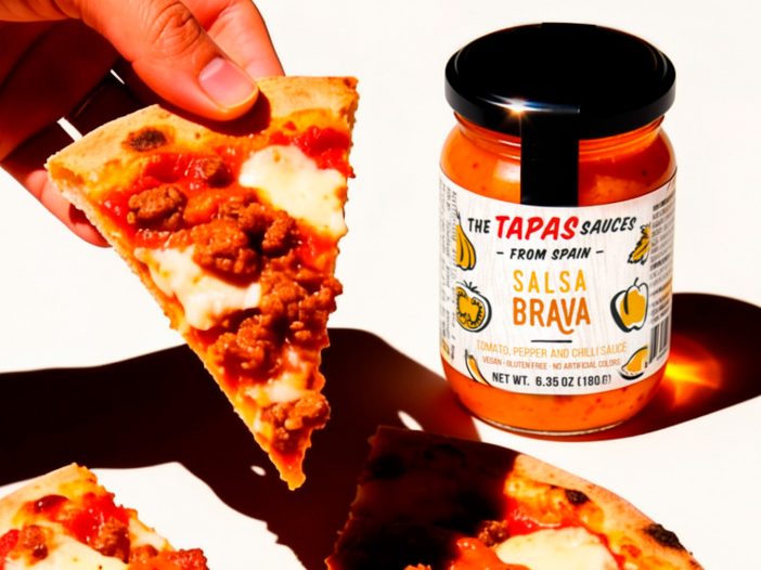 A slice of pizza with salsa brava